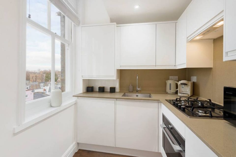 Kitchen | Fully Equipped Kitchen with Stone Work Surfaces | Bespoke Cabinetry | Hardwood Flooring | Hob | Oven | Microwave | Fridge-freezer | Dishwasher | Washer | Coffee Machine | Kettle | Cooking Utensils