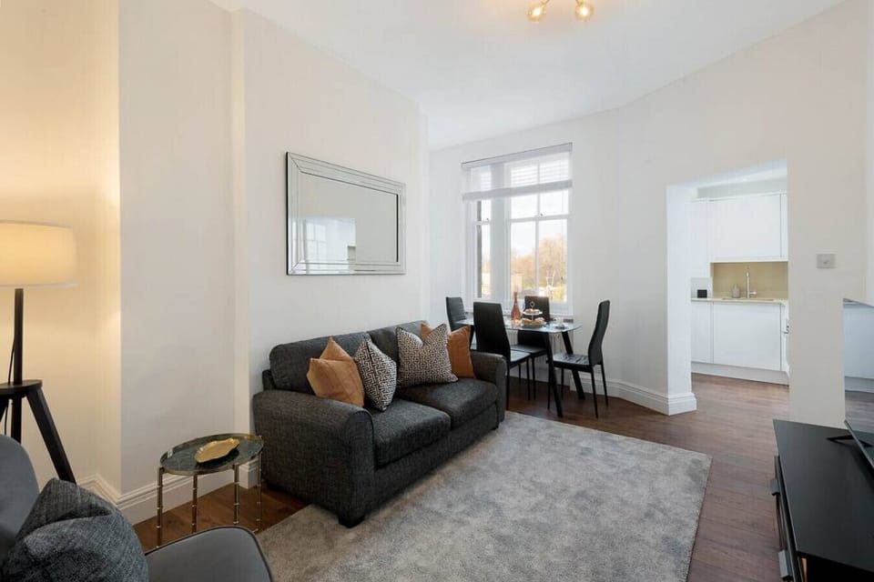Living Room | Open-Plan Space with Hardwood Flooring | Room-Darkening Blinds | Ceiling Lights and Lamp | Wall Mirror | Dining Table and Chairs | Smart TV with Netflix and Amazon Prime | Double Sofa Bed Always Made Up and Ready |
