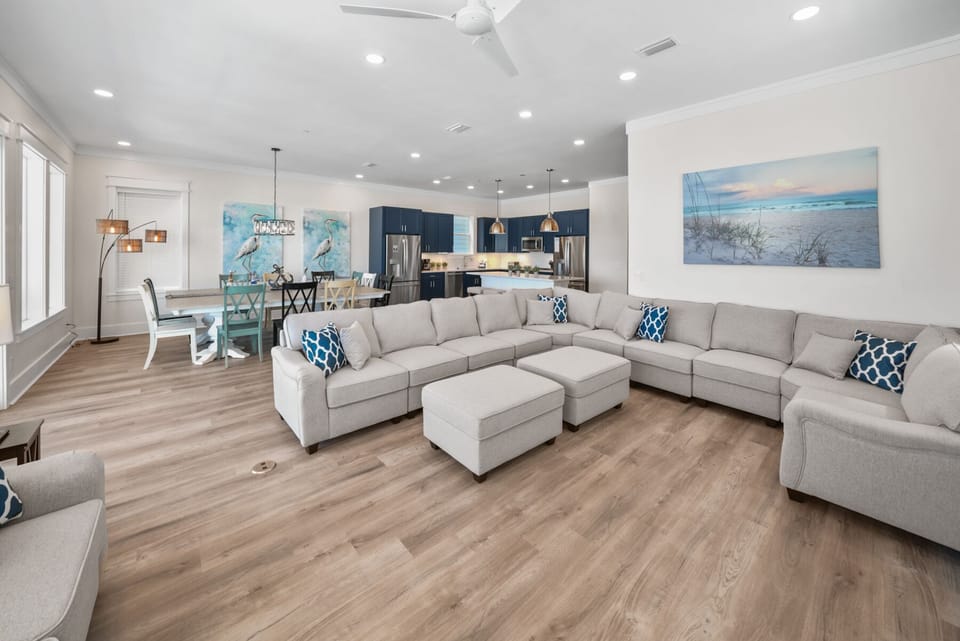 Sink into your spacious sectional sofa with ocean-themed décor while sea breezes from the ceiling fan keep you cool in this bright, open living space.