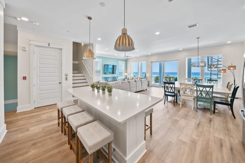 Your open-concept living space flows seamlessly from kitchen to dining, with stunning ocean views framing every moment of your coastal getaway.