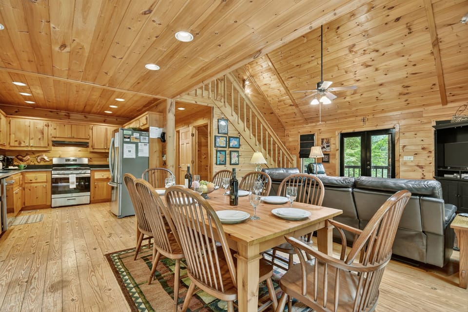 This Blue Ridge cabin rental features a beautiful wood dining table, ideal for family meals or board games