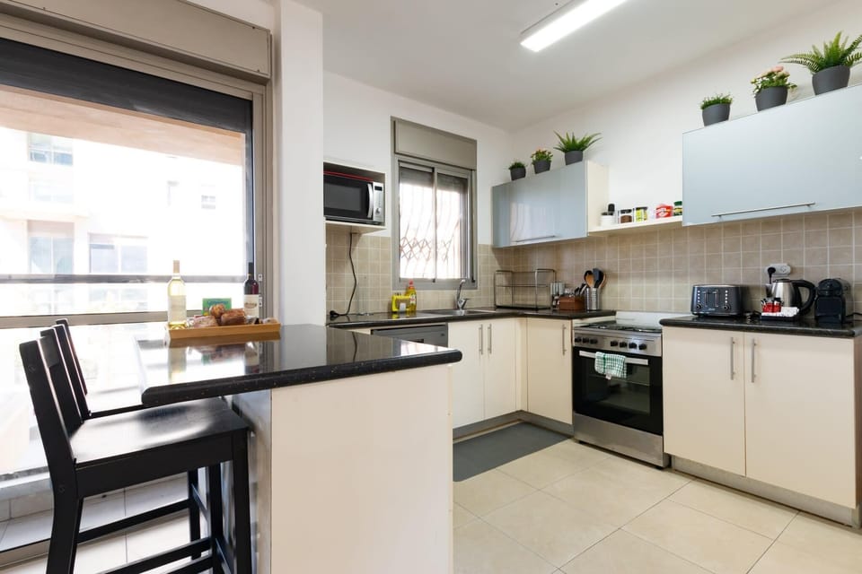 Kitchen bar seating provides dining spot perfect for morning coffee before walks to the beach