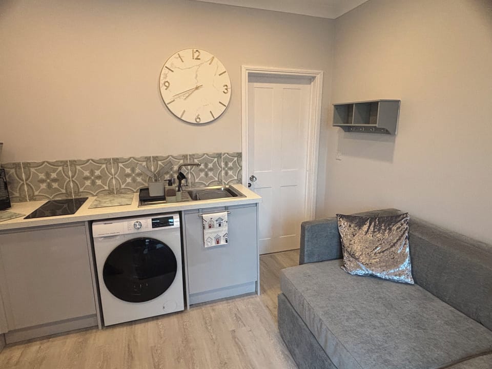 Washer/dryer. Door to bedroom.