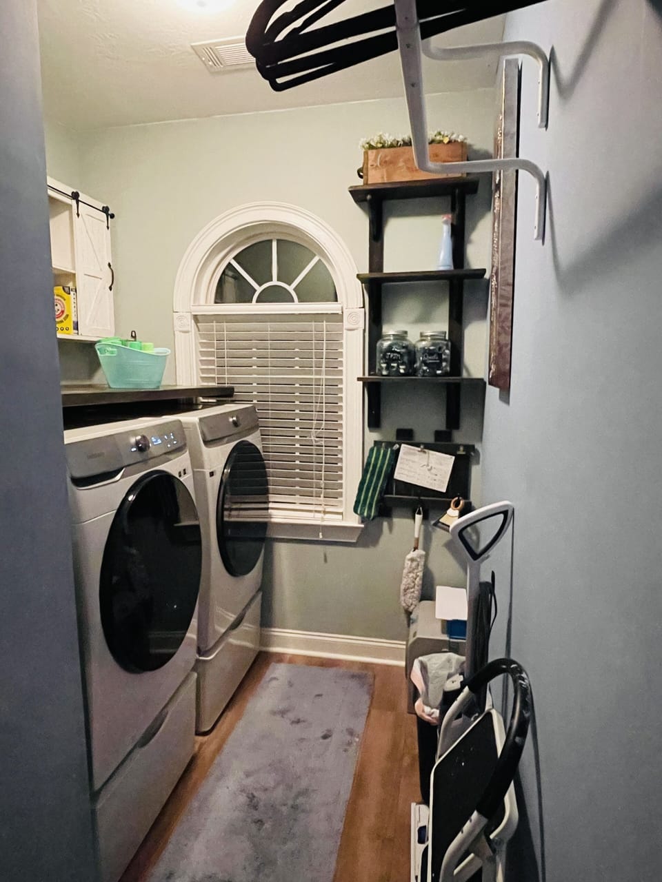 Laundry room with washer, dryer, iron and ironing board.