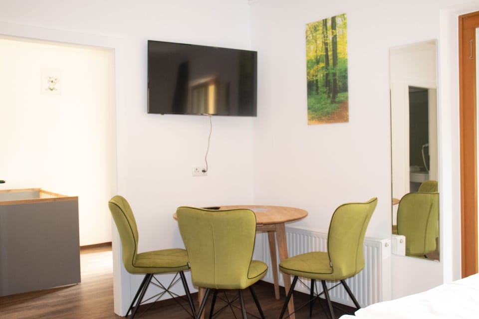 Comfort Triple Room | Living area | 46-inch flat-screen TV with cable channels, TV
