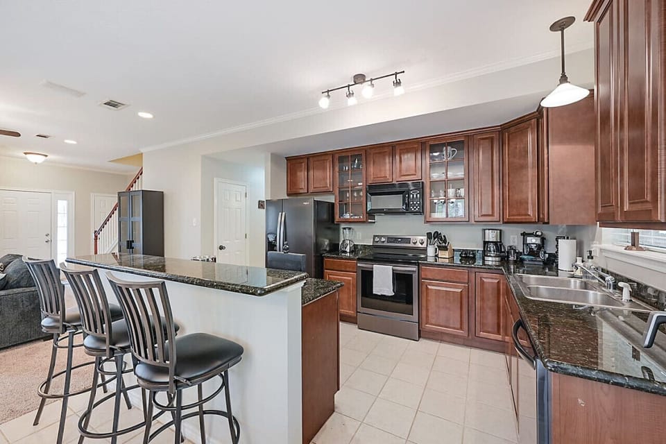 Kitchen with an island and seating for three.