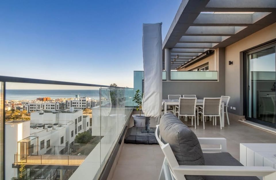 Spacious terrace with glass railings and open views