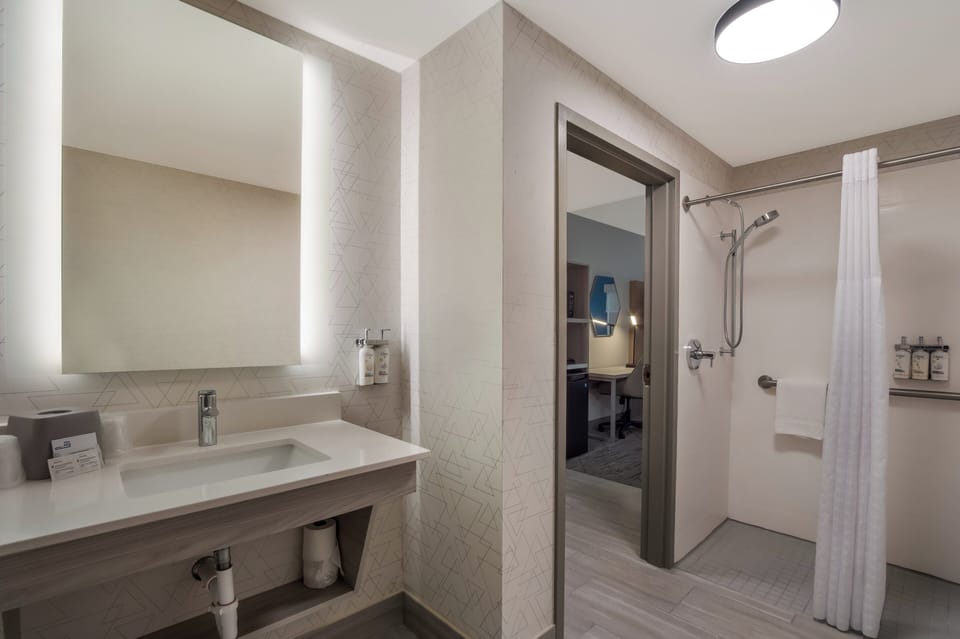 Suite, 1 King Bed, Roll-in Shower (Mobility) | Bathroom | Shower, hydromassage showerhead, hair dryer, towels