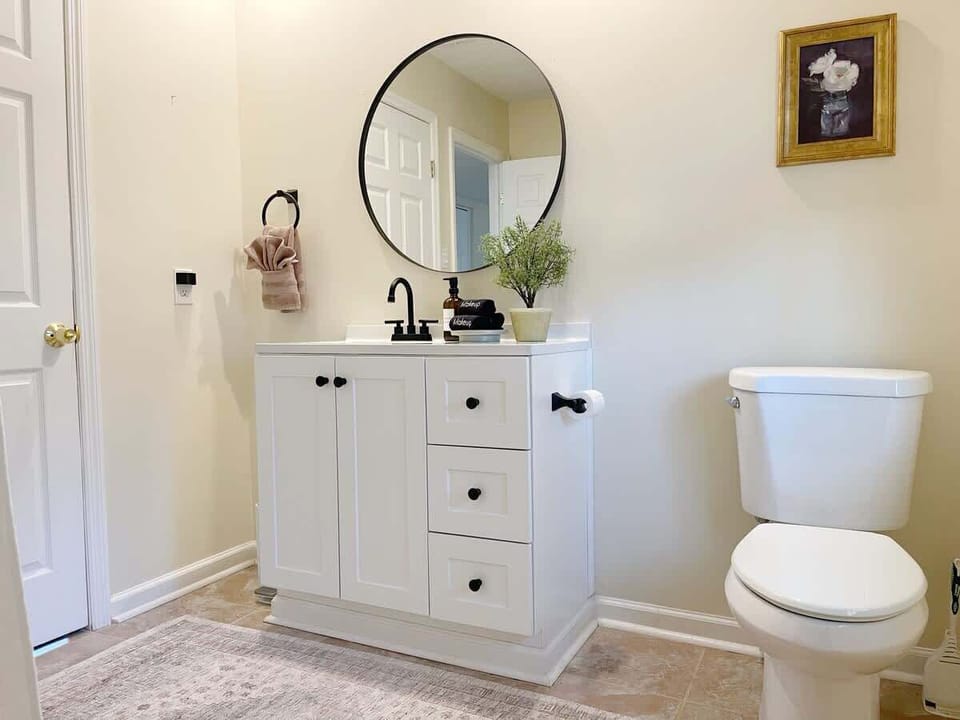 Fresh and Bright - This welcoming bathroom features all the essentials you need, including a large mirror, perfect for getting ready. 