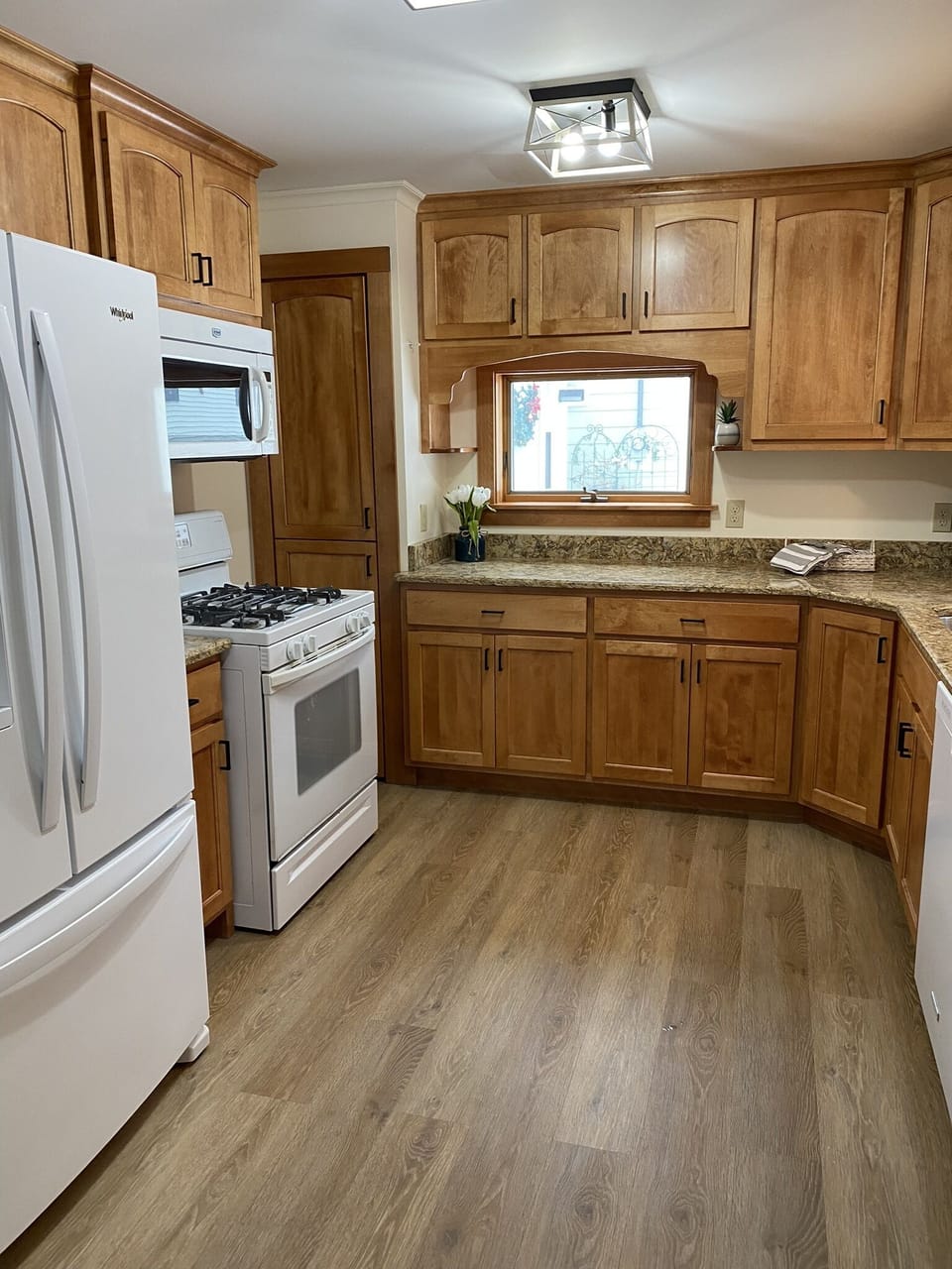 Kitchen with gas stove, fridge, microwave and dishwasher. 