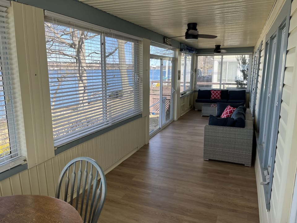 Screened in porch with view of the lake.