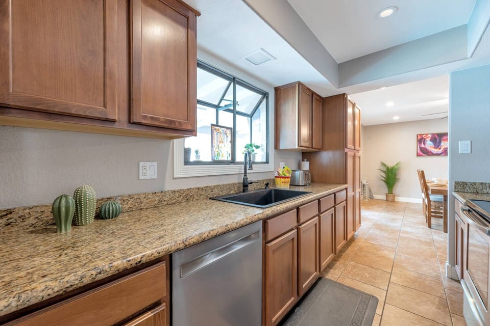 Kitchen with traditional coffee maker, microwave, stove/oven, fridge, dishwasher, utensils etc