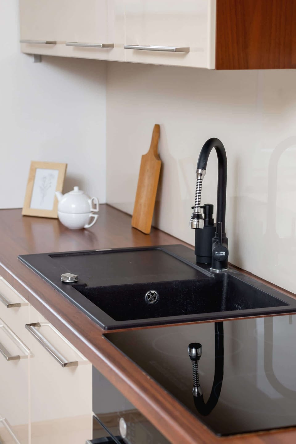 Kitchen with induction hob, fridge, freezer, oven, kitchen utensils, kettle, dishwasher and microwave.