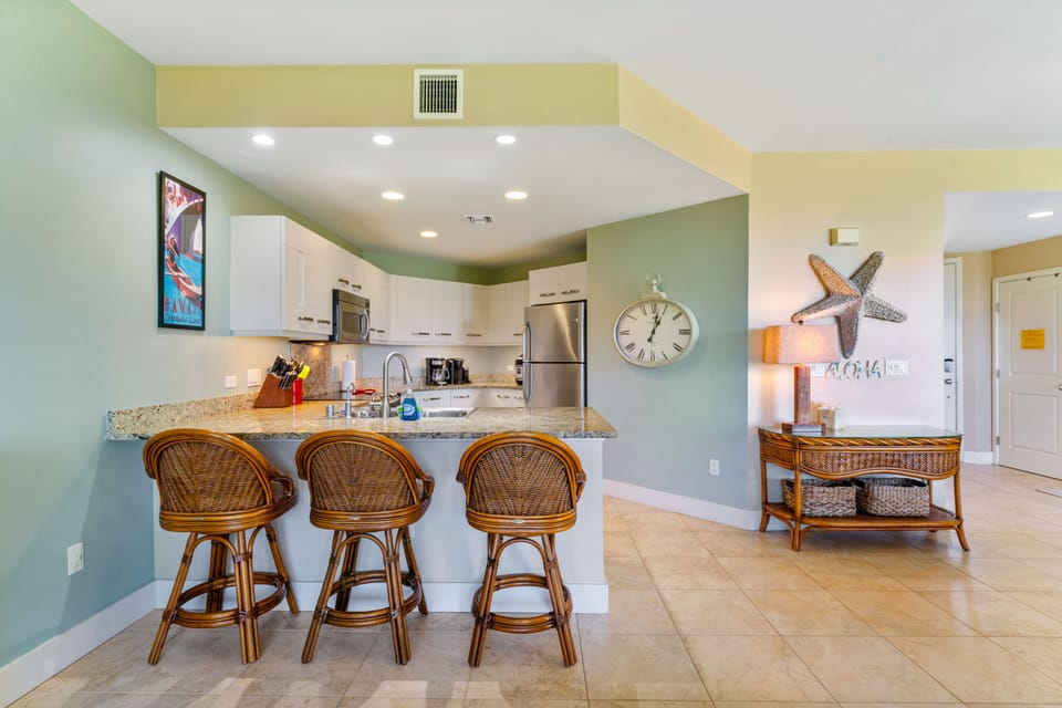 The kitchen is fully stocked and and includes a bar table.