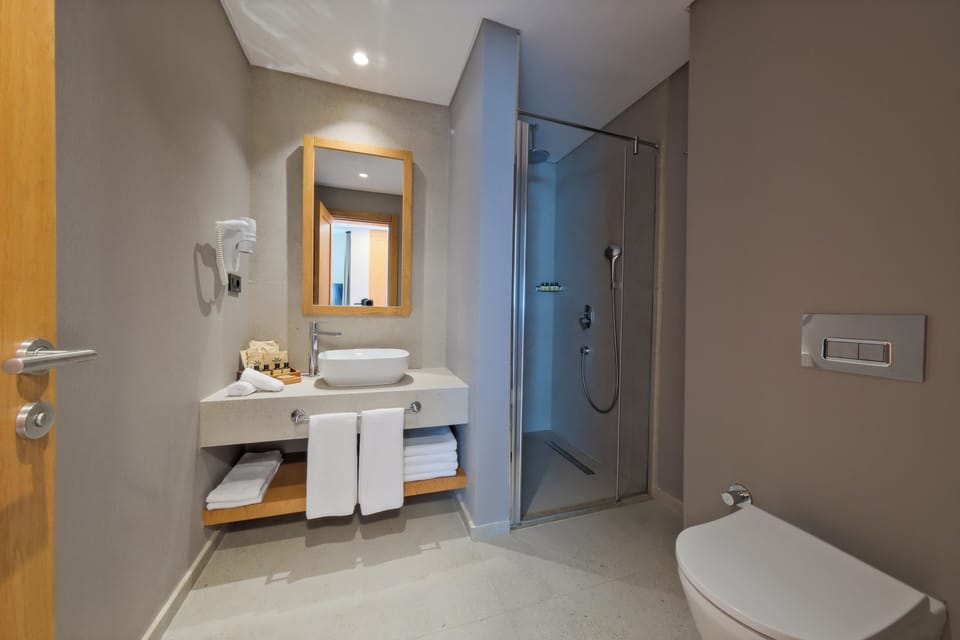 Shower, eco-friendly toiletries, hair dryer, slippers
