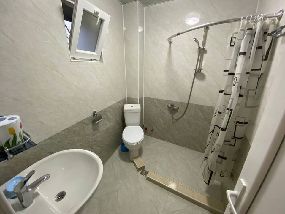 Shower, hair dryer, slippers, towels