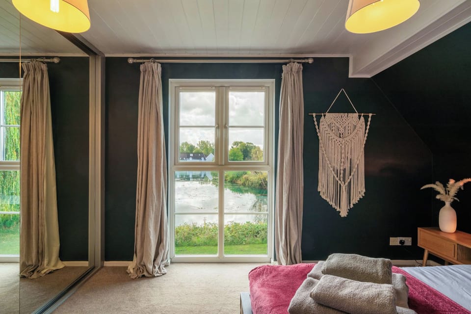 Master Bedroom - Features a Kingsize Barker & Stonehouse Bed with a huge sliding cupboard for luggage and clothing storage and bedside drawers. And the most stunning view of the lake.