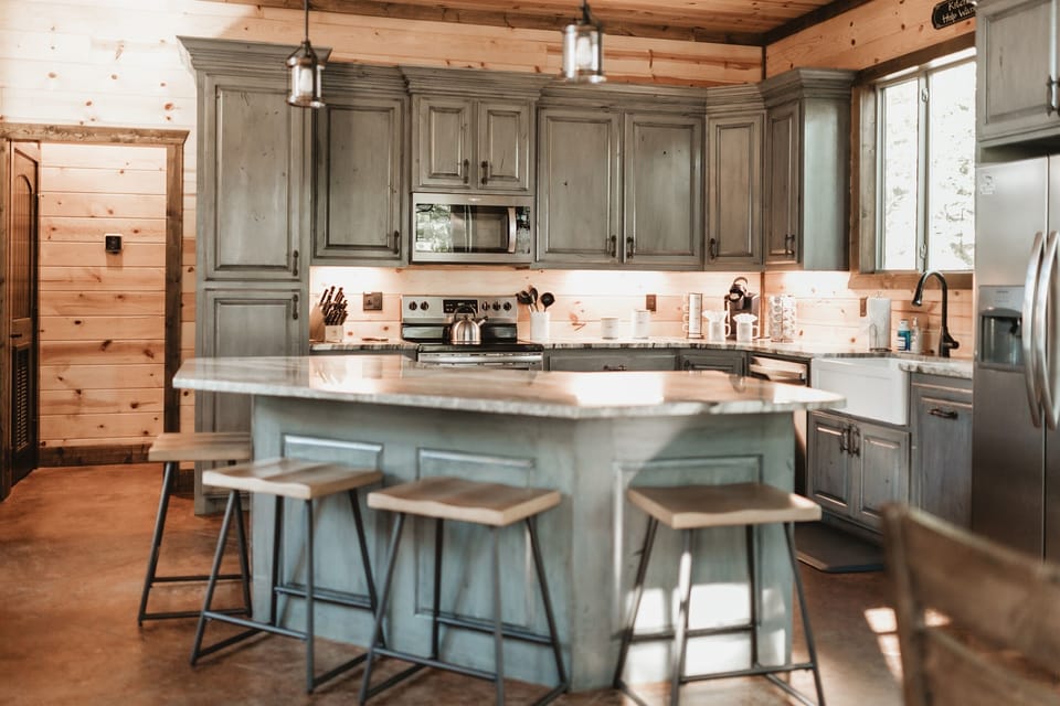 Step into culinary bliss in this stylish kitchen. Those gray cabinets and sleek stools make it the perfect spot for family gatherings.