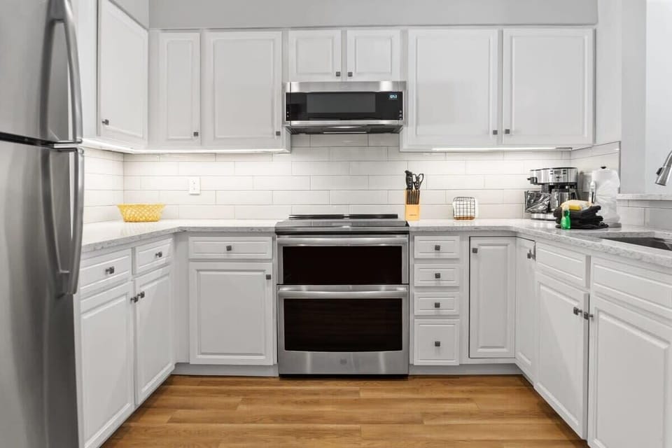 The well-laid-out kitchen is fully equipped with stainless steel appliances, all the basic cookware, and beautiful countertops and cabinets.