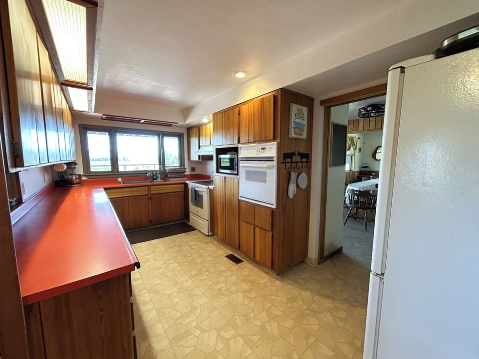 Kitchen with two ovens, microwave and large refrigerator