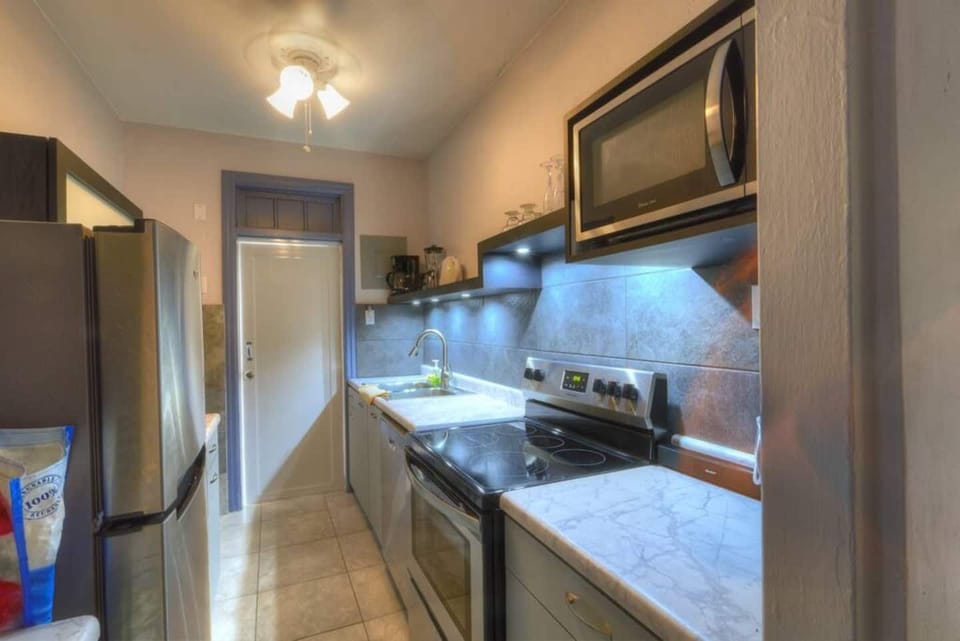 Kitchen with full size stove, dishwasher and fridge.
