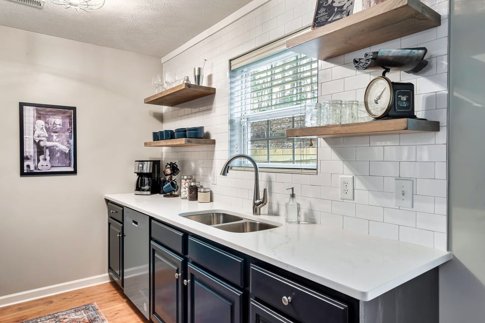 Renovated kitchen has new stainless-steel appliances and quartz countertops