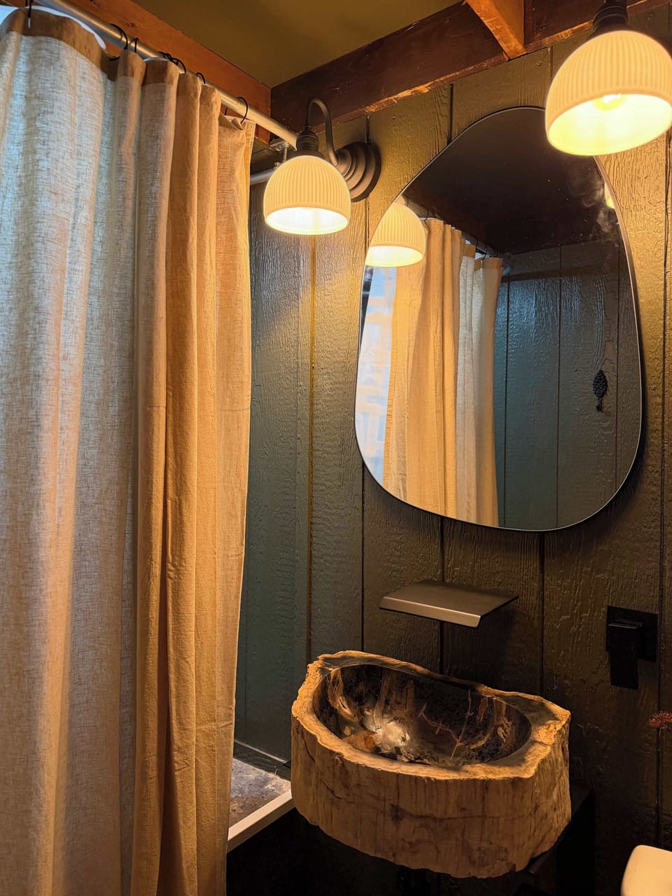 Bath Oasis: Natural wood sink and soft lighting create a tranquil retreat for your getaway!