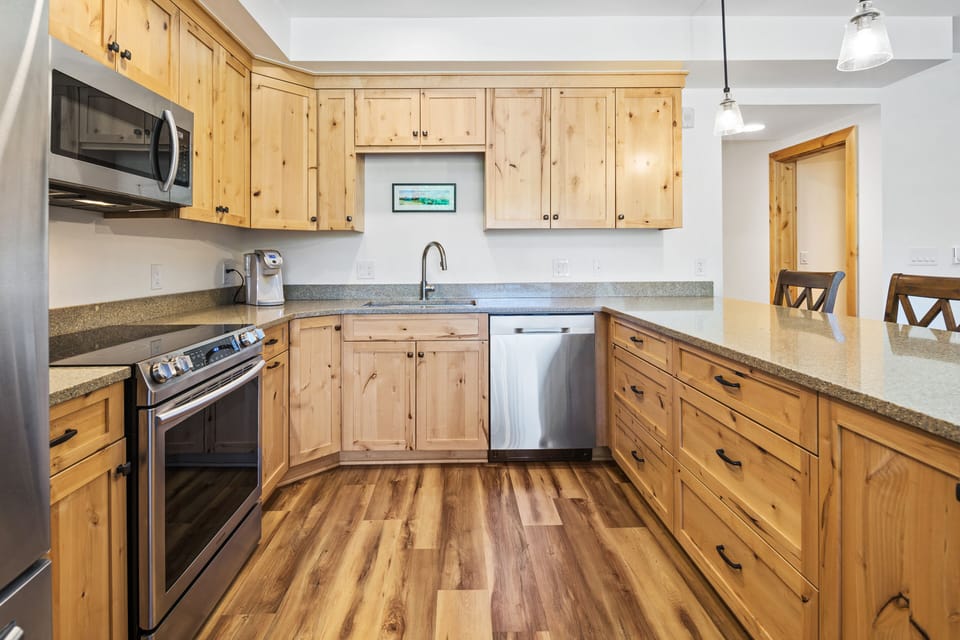 Well-stocked kitchen w/ electric stove, oven, dishwasher, fridge and microwave.