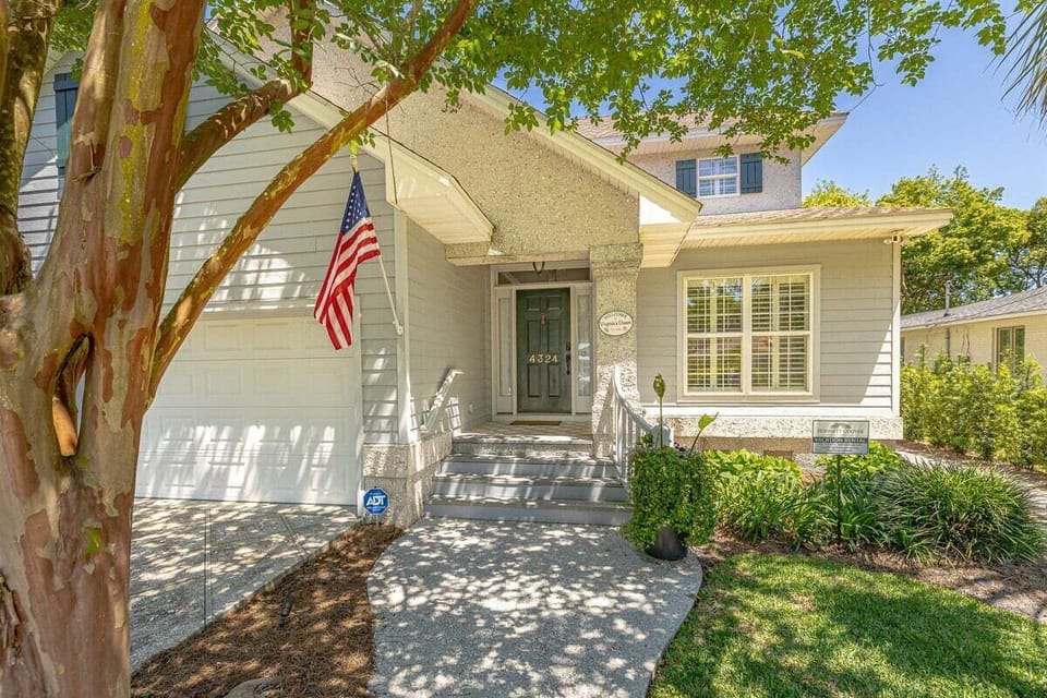 Front property exterior with American flag and front steps