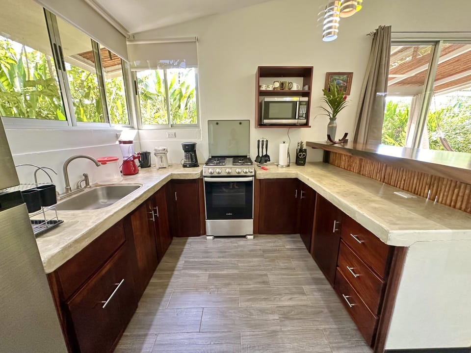 Fully equipped kitchen including gas stove, oven, microwave, coffee-maker, etc