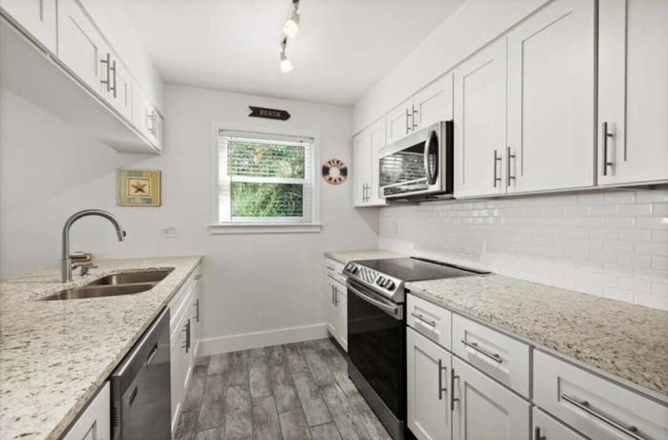 Lots of granite counter space and all you need is in this well-equipped kitchen.