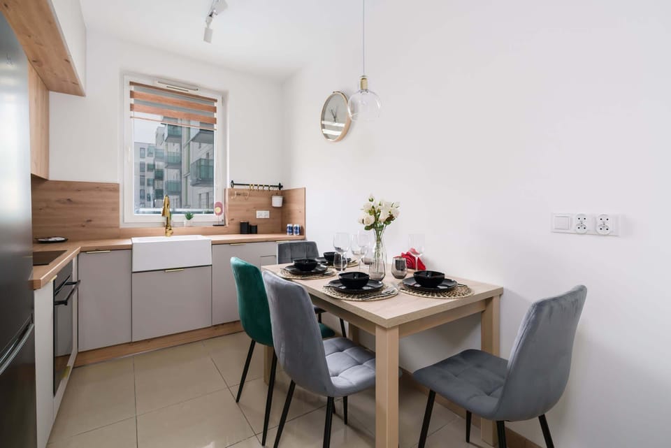 The kitchen's sleek design includes all necessary cookware and utensils. 
