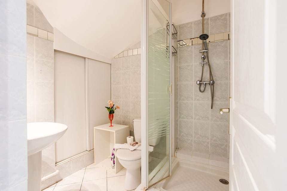 The bathroom with shower and toilet
