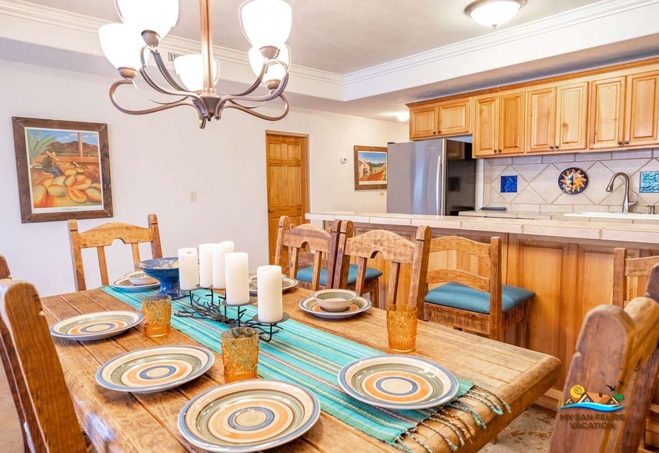 The dining room at Casa Sonora sits right next to the kitchen, making it easy to serve meals straight from the stove. The large table offers plenty of seating for group dinners and family meals .