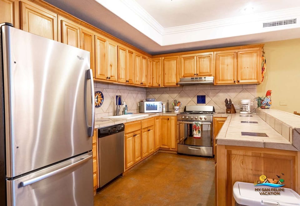 Full-size refrigerator with ample storage space in the kitchen of Casa Sonora — perfect for keeping groceries cold during your stay. Includes ice maker and filtered water dispenser .