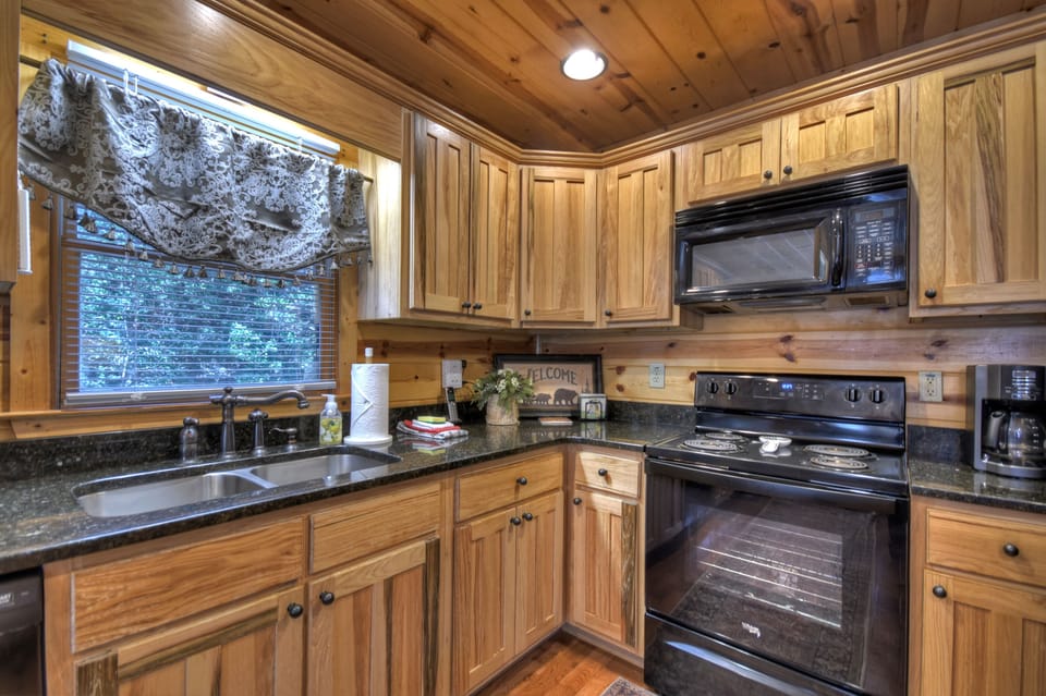 Granite countertops with stunning black appliances 