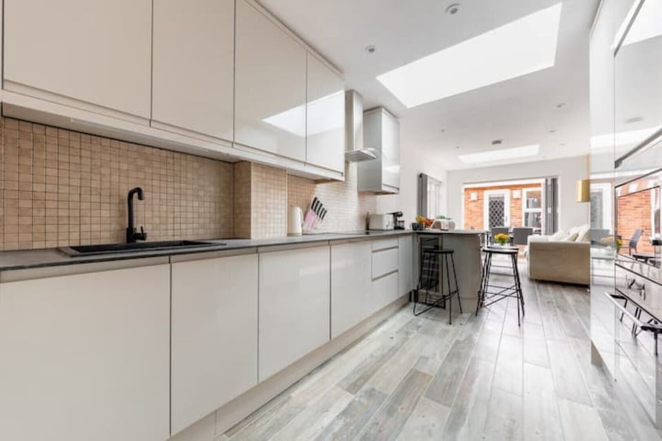 Kitchen with fridge, freezer, microwave, coffee machine, toaster, dinnerware,etc