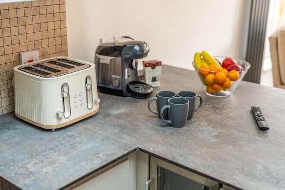Kitchen with toaster, dishwasher, coffee machine, wine cooler,fridge and freezer