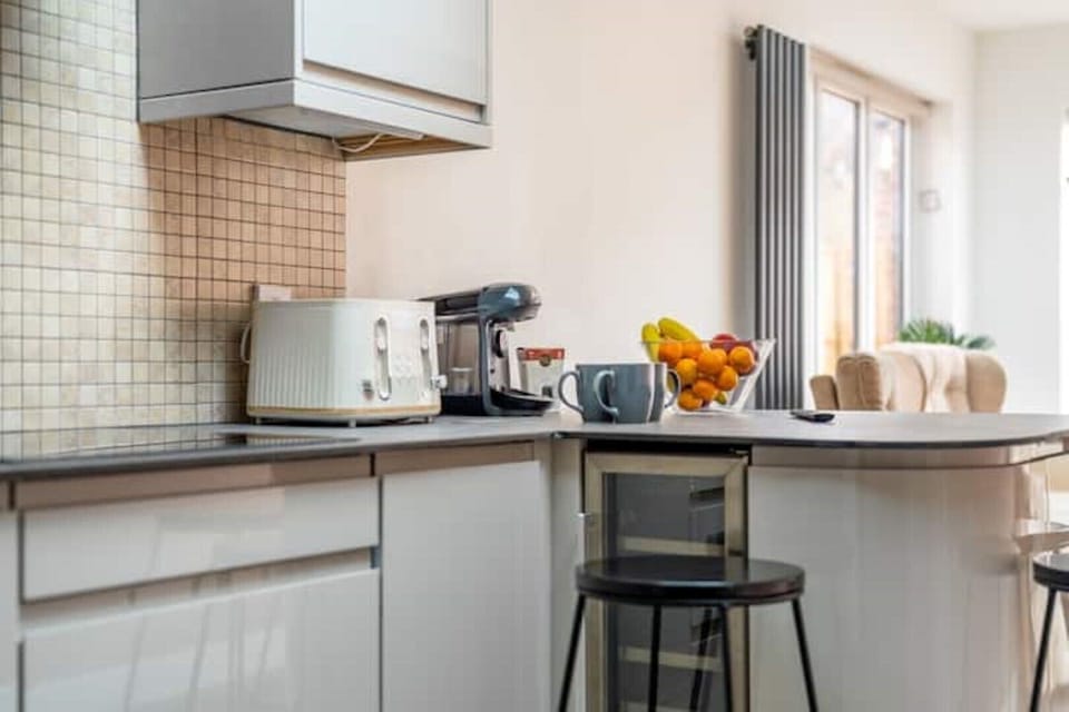 Kitchen with toaster, dishwasher, coffee machine, wine cooler,fridge and freezer