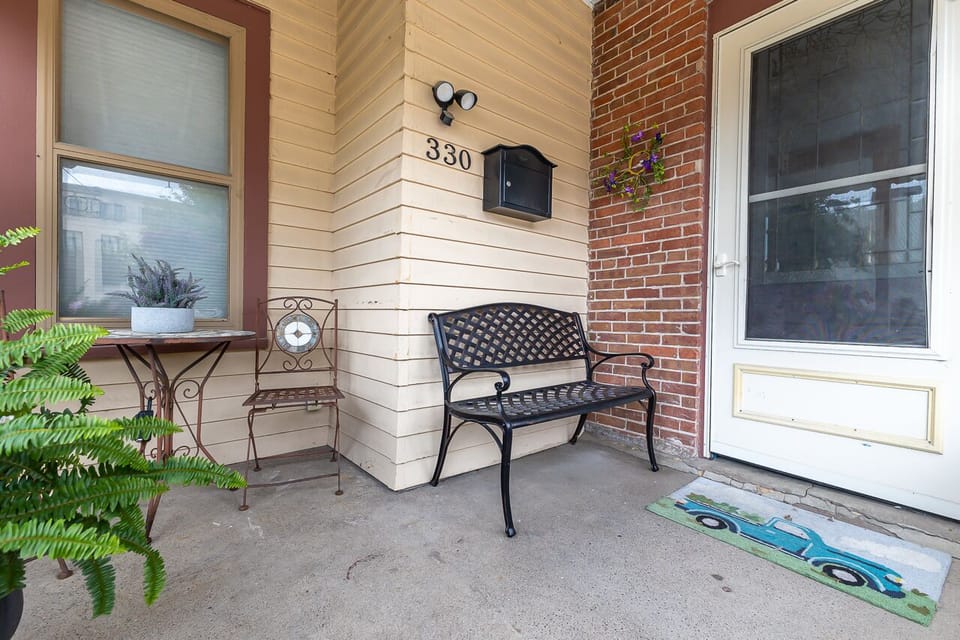 Front porch. Bench with small table and two chair. View of the Redstone Inn!