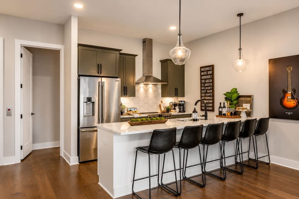Open, modern kitchen with a 6-seater island ready for meals and conversation.
