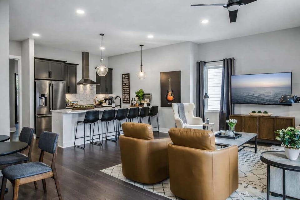 Open layout for cooking, relaxing, and dining with extra seats.