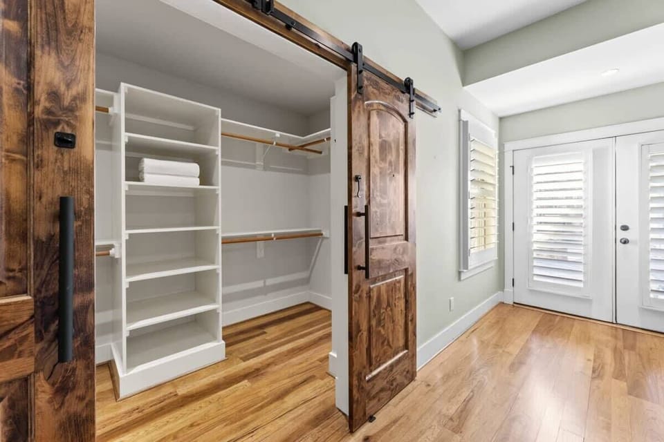 Barn door walk in closet in bedroom 1