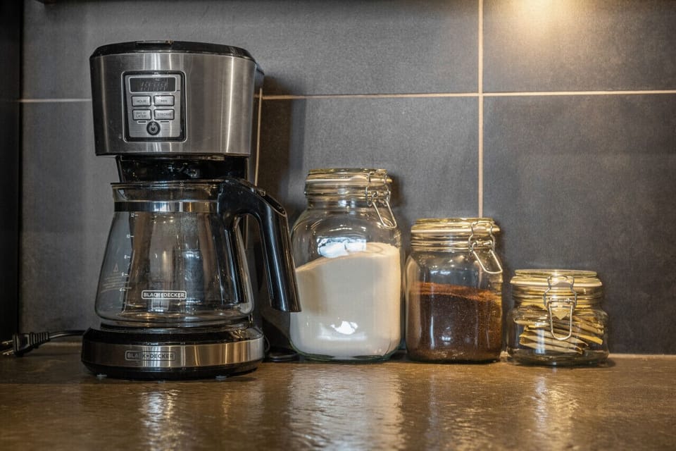 Full kitchen with a drip coffee maker, ground coffee, tea, sugar, and basic condiments (ketchup, mustard & relish.)
