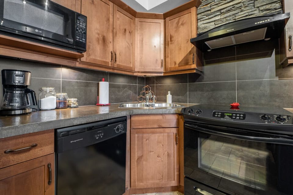 Full kitchen with a drip coffee maker, ground coffee, tea, sugar, and basic condiments (ketchup, mustard & relish.)