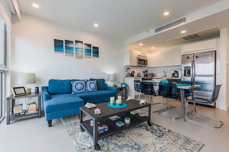 Settle into your bright, modern living space with coastal touches. The cozy sofa, fully equipped kitchen, and thoughtful details create the perfect home base for your getaway.