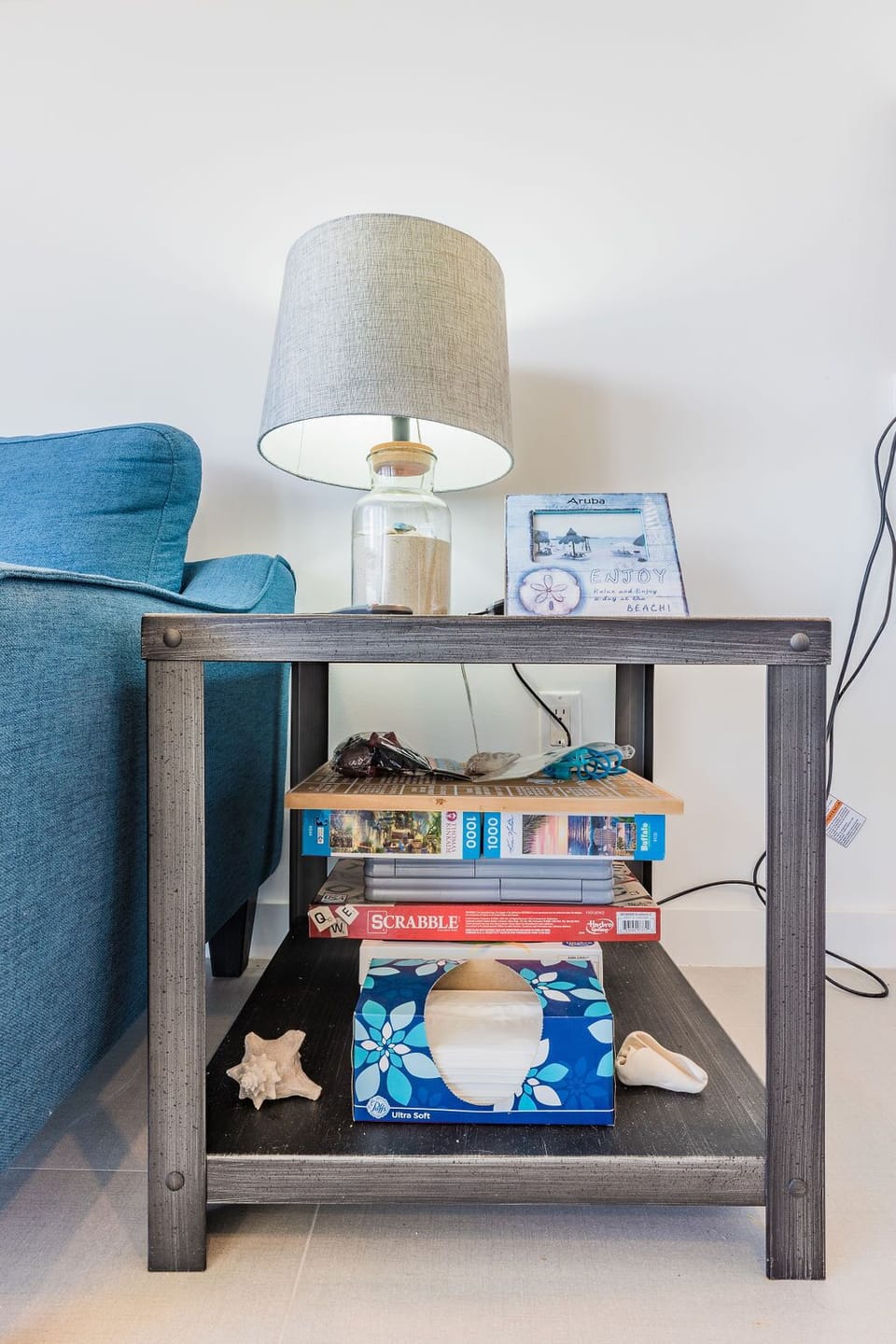 Settle in beside your cozy living room, where a charming side table holds beach-inspired decor and board games for your evenings of relaxation.