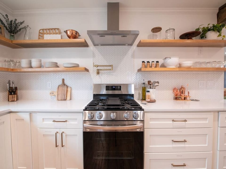 The kitchen is a fully equipped chef's kitchen with a gas stove, vent hood, and all the cookware you need to feel at home.