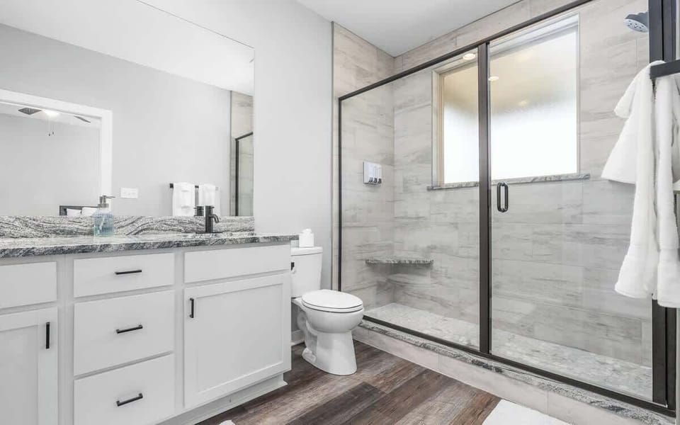 Unwind in the spacious master bath featuring dual sinks and a sleek walk-in shower.
