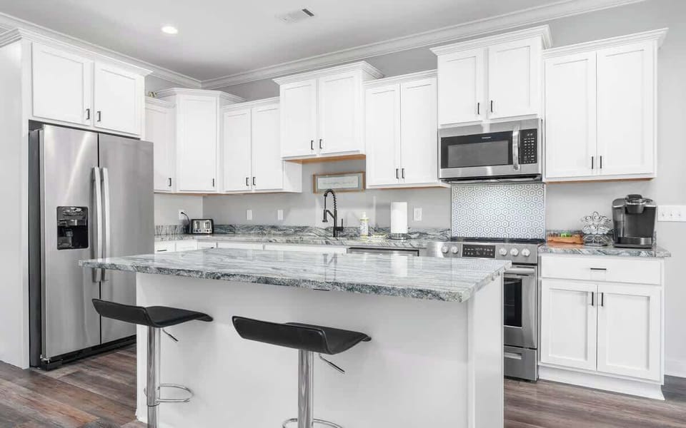 A bright kitchen with a large island—perfect for cooking, dining, or gathering with friends.